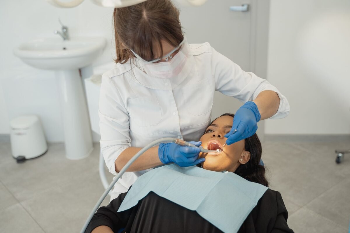 Patient receiving a professional teeth cleaning in the dental chair